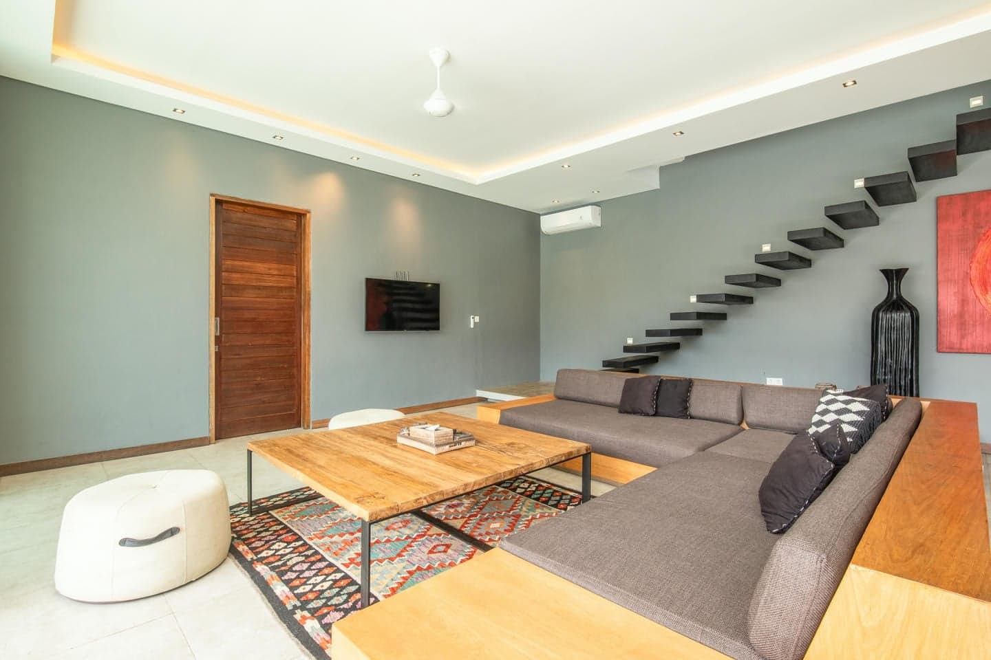 Villa Niko Dua — living room with floating staircase