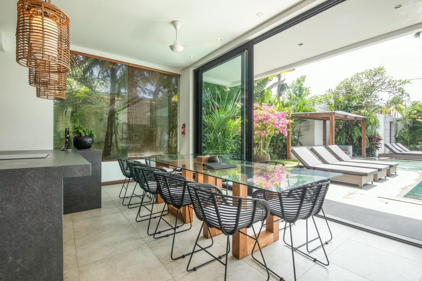 Villa Niko Dua — dining table for eight beside the pool