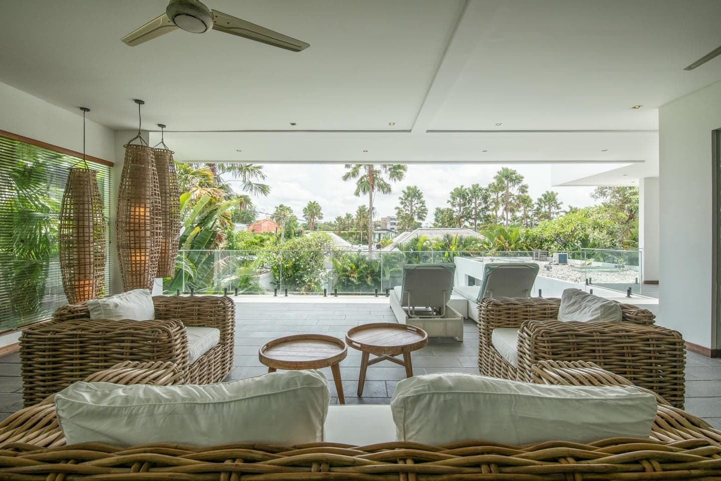 Villa Niko Dua — upper-floor terrace lounge above the treetops